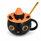Taza de gato negro con tapa naranja y cuchara dorada